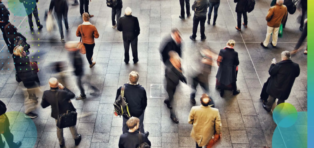 High angle view of commuters passengers and business travellers waiting in a busy train station
