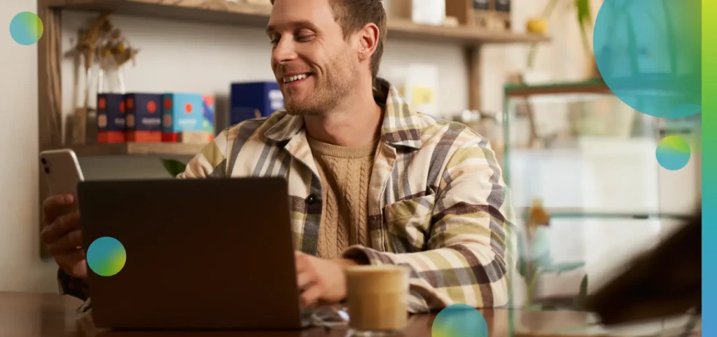 Lifestyle portrait of young businessman, freelancer sitting in cafe