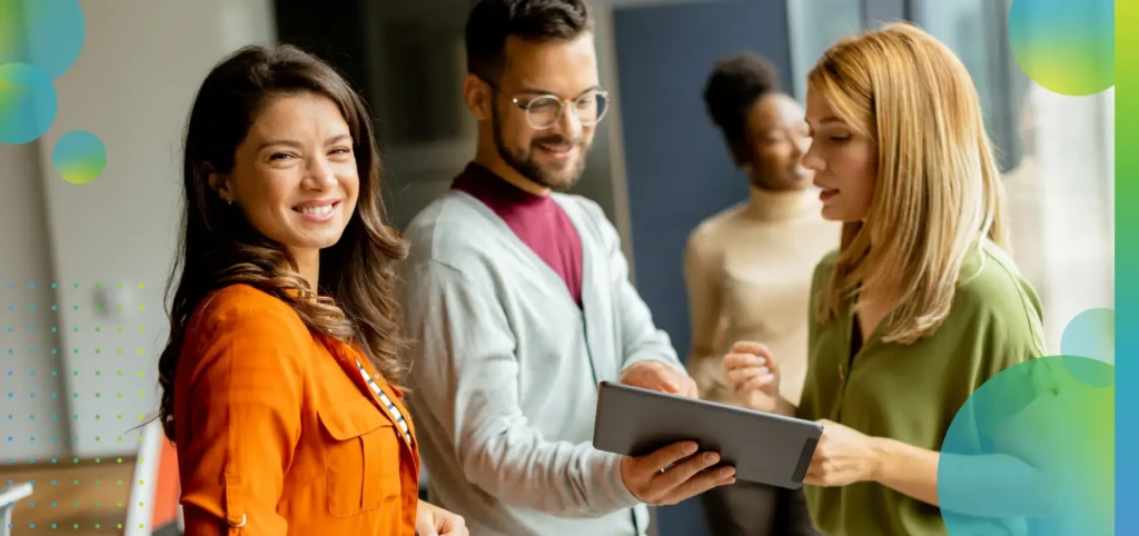 Young business woman standing in front of her team at the office.