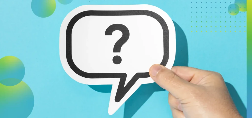 Hand holding a question mark on speech bubble on blue background.