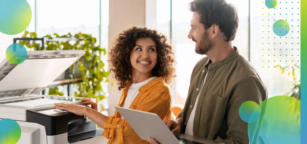 Business partners using printer and laptop in office