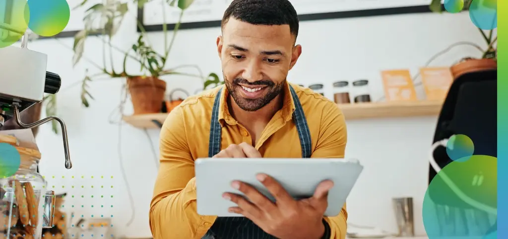 Man Managing Cafe Business Using Tablet 